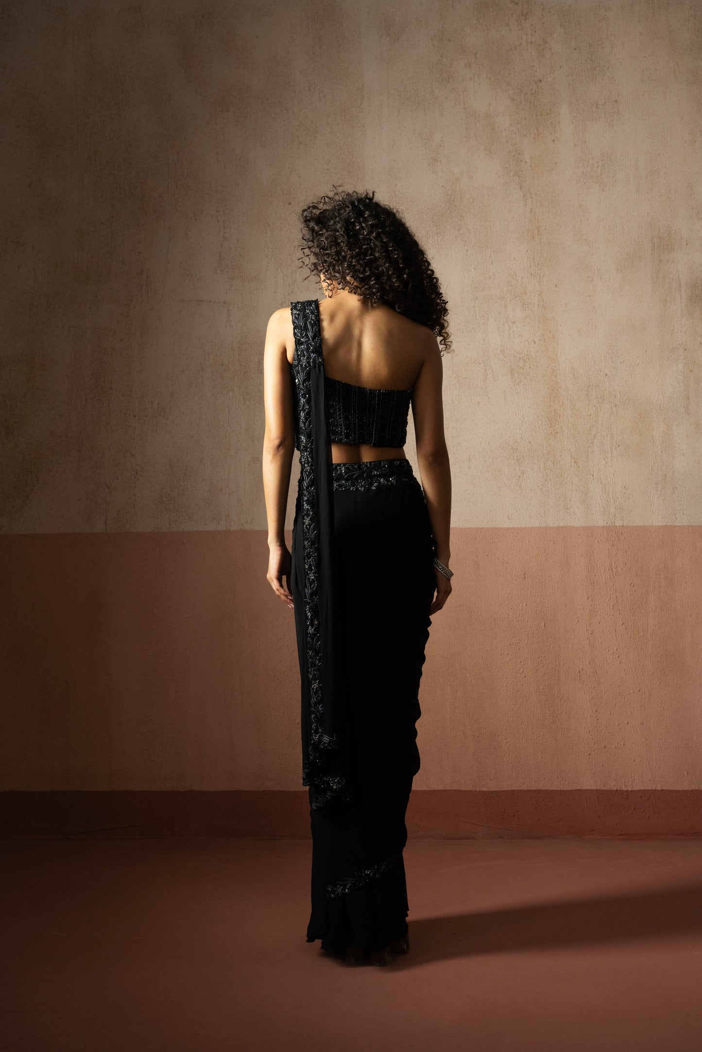 Black one shoulder corset draped saree